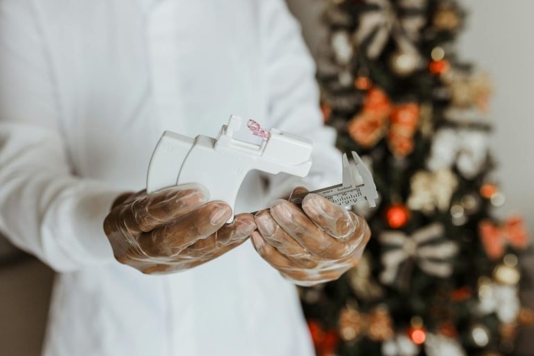 Close-up of a medical professional preparing a piercing kit indoors near a decorated Christmas tree.